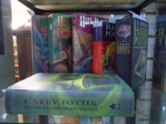 Six hardback Harry Potter books, four being American First Editions, and two English First Editions.