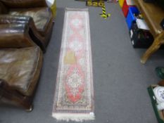 A modern Turkish silk runner with three floral spandrels, 197 x 46cms