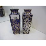 A pair of colbalt blue heavy vases approx height 15cms with ornate white metal flower decoration AF