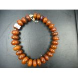 Large string of amber coloured beads, purchased from the Gold Coast