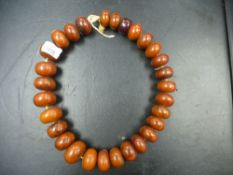 Large string of amber coloured beads, purchased from the Gold Coast