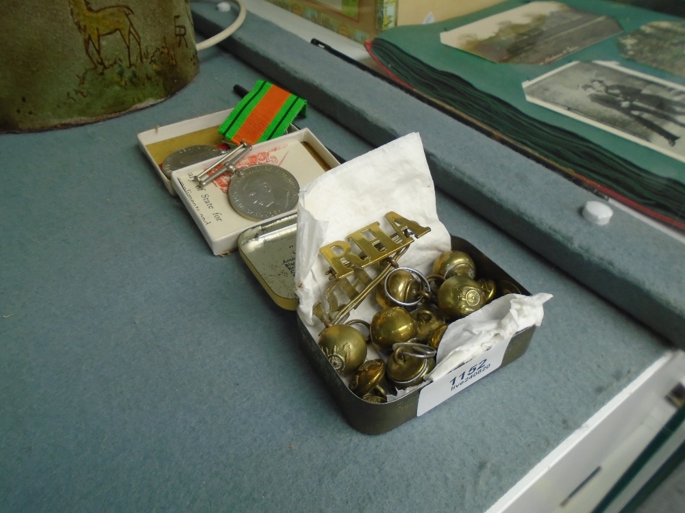 Two WWII medals and military badges and buttons