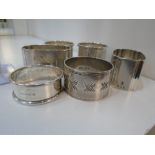 Six hallmarked napkin rings of assorted design all hallmarked approx 4.9 ozt, accompanied by
