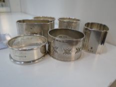 Six hallmarked napkin rings of assorted design all hallmarked approx 4.9 ozt, accompanied by