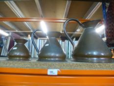 A set of 4 graduated copper measuring jugs