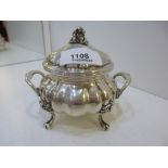 A silver decorative pot with lid and two handles of a foreign background, marked 800, on four claw