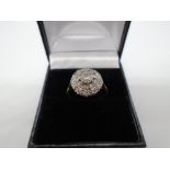 18 carat gold diamond cluster ring with a central diamond approx 0.5 carat diamond - gross weight
