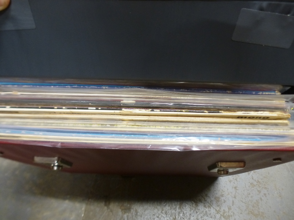 A carry case of vinyl LPs, including Elvis Presley
