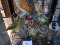 A shelf of Beswick birds, including owls, Goldfinch, Greenfinch, Stone Chat, White Throat, etc