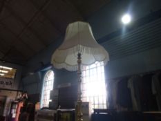 A brass standard lamp and shade