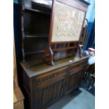 A reproduction oak dresser and rackback having linen fold doors