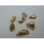 Seven 9ct yellow gold charms, to include a hedgehog, rabbit, fish, bird, etc, marked 375, approx 9g