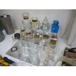 A quantity of cut glass ink wells, alongside a quantity of glass measures, etc