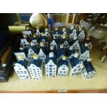 A quantity of blue delft porcelain bottles in the form of dutch houses