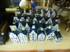 A quantity of blue delft porcelain bottles in the form of dutch houses