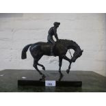 A bronzed figure of horse and jockey on oblong base - tail repaired - height 26cms