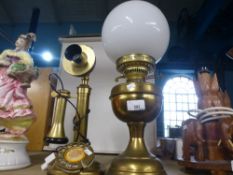 A brass British Ericson telephone with a brass oil lamp