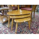 A nest of three Ercol pebble tables