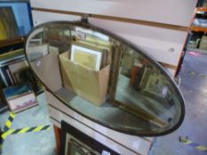 A lead backed oval bevelled edged mirror and two framed pictures