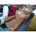 A pair of modern brown leather club armchairs on bun feet