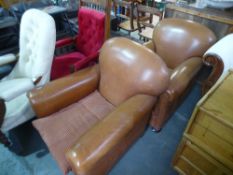 A pair of modern brown leather club armchairs on bun feet