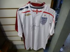 A signed 2007-2009 England shirt by John Barnes, together with a Liverpool shirt signed by John