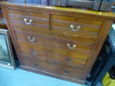 A late Victorian satin walnut chest of drawers on plinth base and an antique foldover table