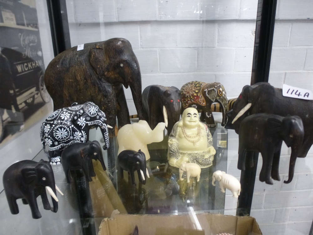 A shelf of carved elephant figures, mostly wood, etc - Image 3 of 3