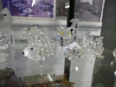 A quantity of small glass ornaments, mostly Swarovski, along with others and two glass dolphins by