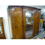 A Victorian Burr Walnut and mahogany triple wardrobe having central mirror door, 228 cms