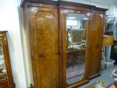 A Victorian Burr Walnut and mahogany triple wardrobe having central mirror door, 228 cms