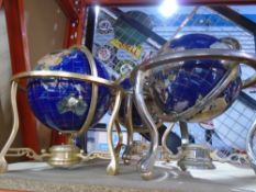 Three globes on stands made with various crystals and shell