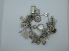 Sterling Silver charm bracelet with many charms including St Christopher, horseshoe, etc