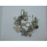 Sterling Silver charm bracelet with many charms including St Christopher, horseshoe, etc