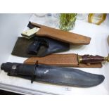 Two leather holted vintage air pistols and a sheathed diver's knife and one other
