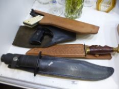 Two leather holted vintage air pistols and a sheathed diver's knife and one other