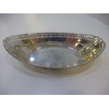 A silver bon bon dish of oval form decorated and pierced design with beaded rim stamped Sheffield