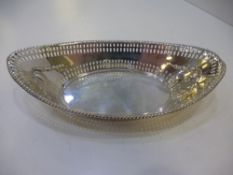 A silver bon bon dish of oval form decorated and pierced design with beaded rim stamped Sheffield