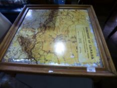 A square coffee table having a mapped top of the Dominion of Canada, with a painted oak cupboard
