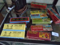 A child's vintage tin slide projector with a quantity of boxed and unboxed slides to include some