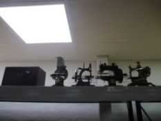 A Dorman lockstitch sewing machine with box and three other miniature machines