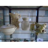 A shelf of pottery items, a vase and jug by Hillstonia, a lidded dish by Canterbury pottery and an