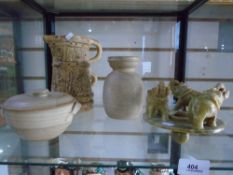 A shelf of pottery items, a vase and jug by Hillstonia, a lidded dish by Canterbury pottery and an