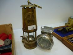 A brass miner's lamp and a Lucas silver king lamp