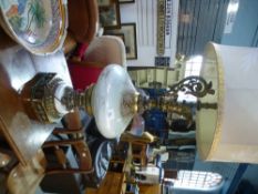 A pair of ornate glass and metal mounted table lamps