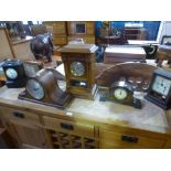 Five various clocks including a slate mantle clock and an oak 8 day example