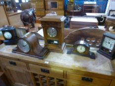 Five various clocks including a slate mantle clock and an oak 8 day example