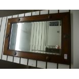 A rectangular oak framed bevelled edge mirror