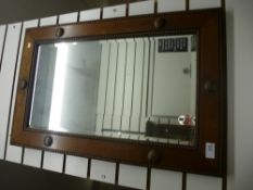 A rectangular oak framed bevelled edge mirror