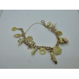 9ct yellow gold charm bracelet hung with 14 gold charms including ship, elephant, Pegasus, etc